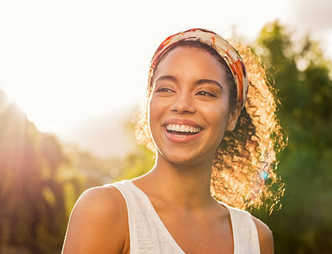 Woman smiling outdoors.