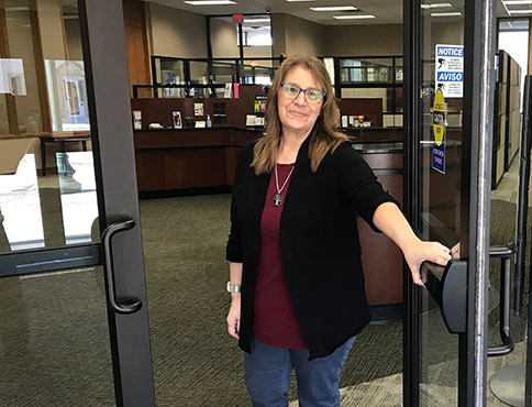 FBH Employee opening the bank's front door.
