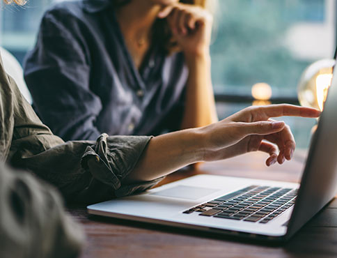 Man and woman looking at laptop.