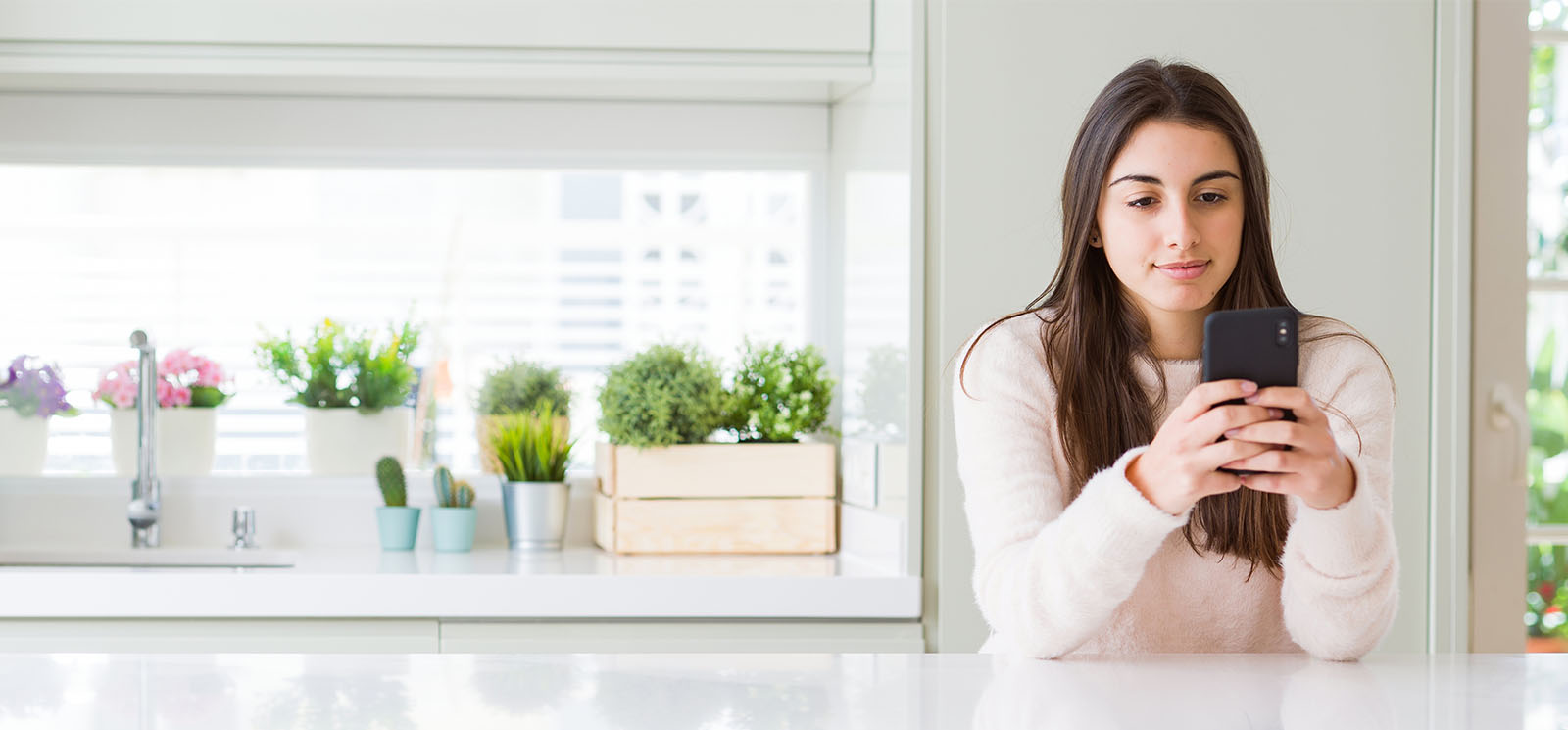 Young woman sending a message using cellphone with a confident expression thinking seriously