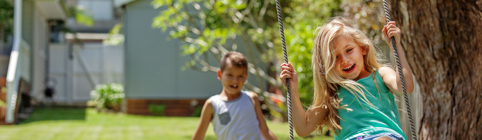 Kids on backyard swing.