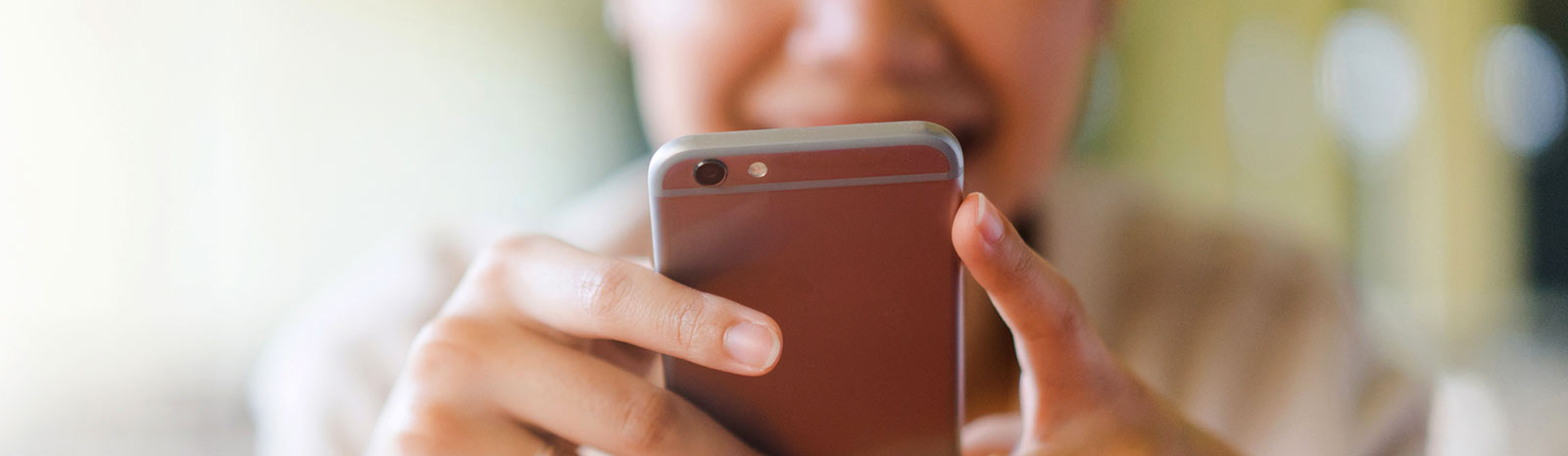 Close up of woman holding mobile phone.